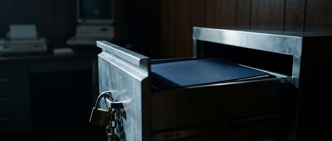 An unlabelled folder inside a locked steel document drawer